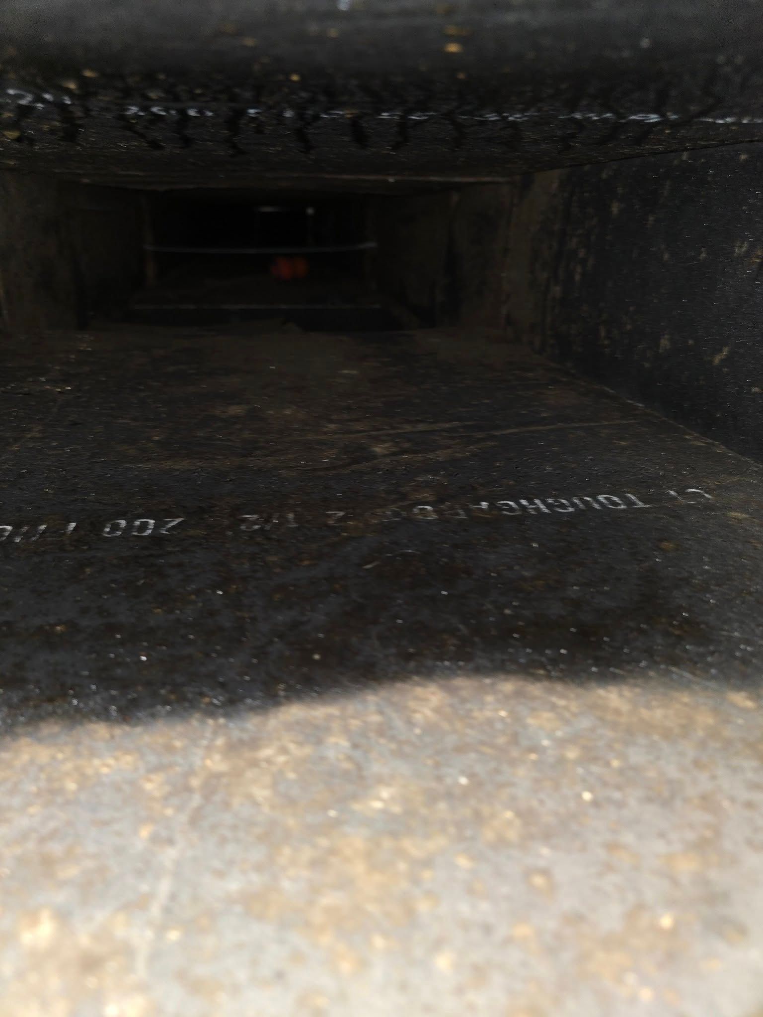 A close up of a hole in a wall that looks like a tunnel.