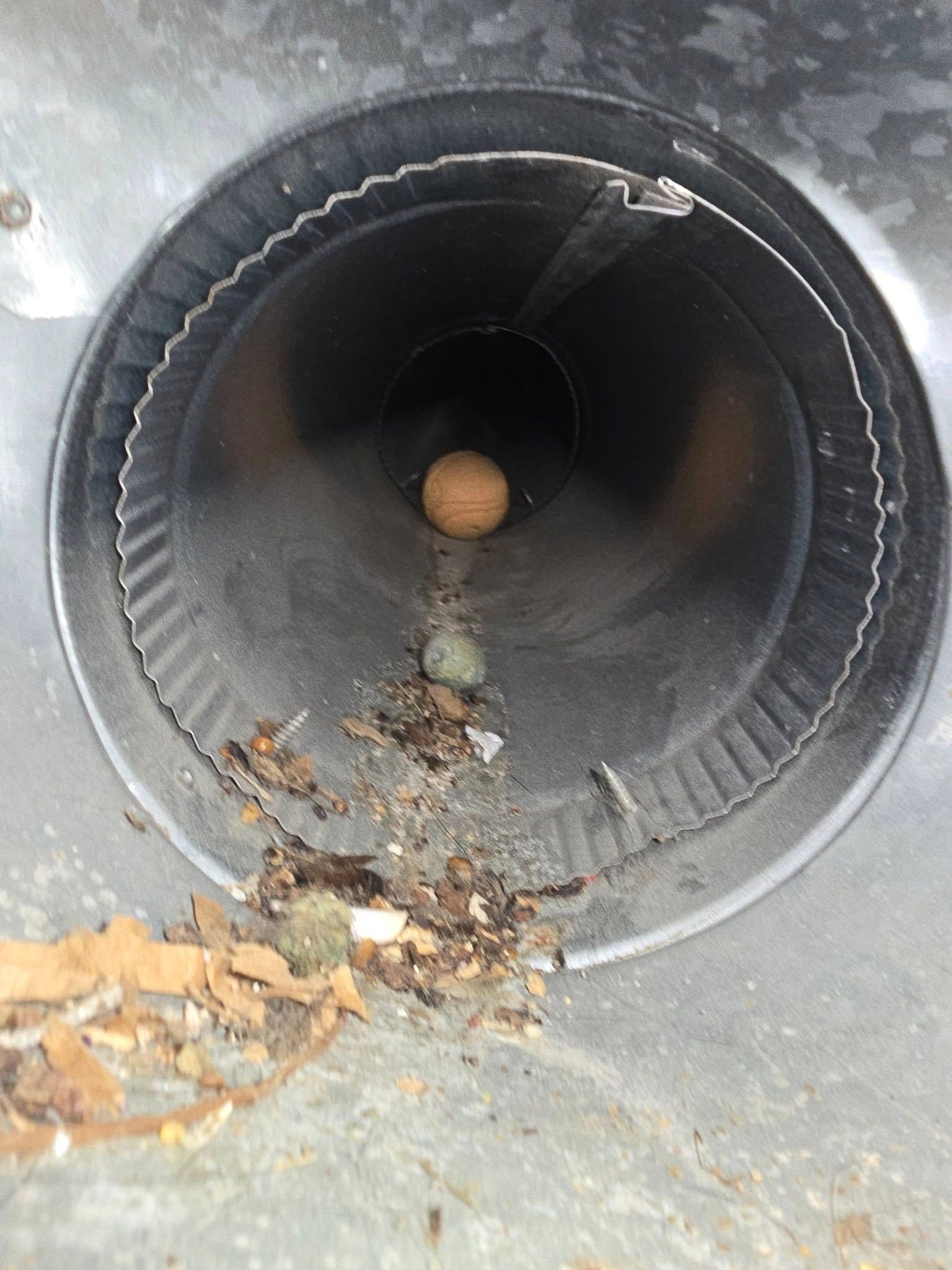 A close up of a metal pipe with a ball in it.