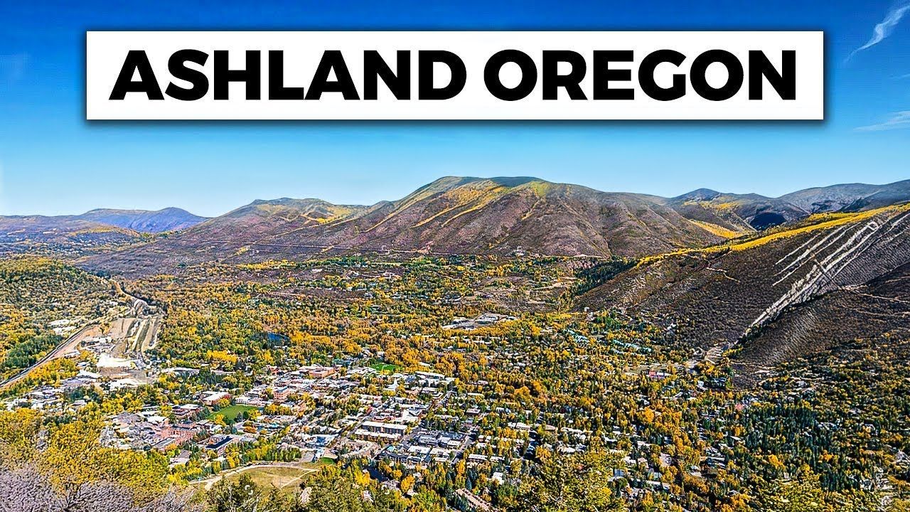 An aerial view of ashland oregon with mountains in the background.