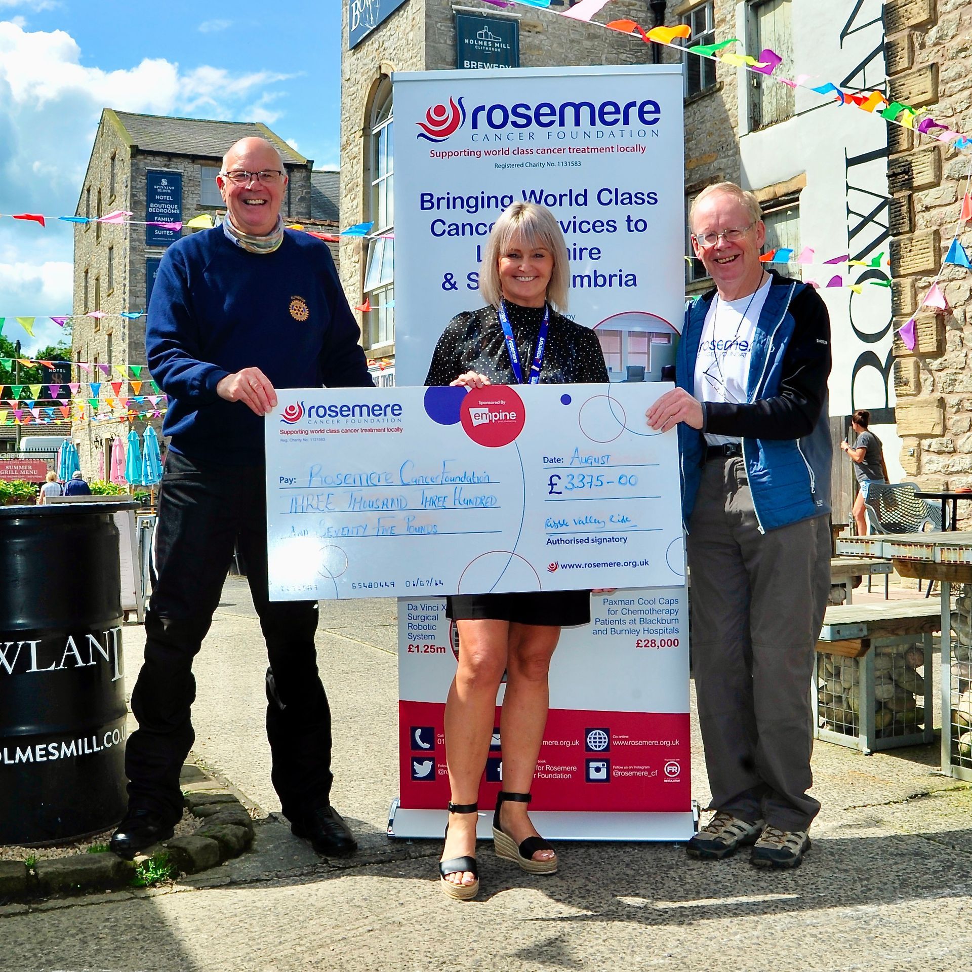 Ribble Valley Ride organisers John Spencer (left) and Bill Honeywell (right) hand over a cheque for £3,375 to Rosemere Cancer Foundation fundraising manager Sue Swire. Image © Mark Sutcliffe/Salar Media