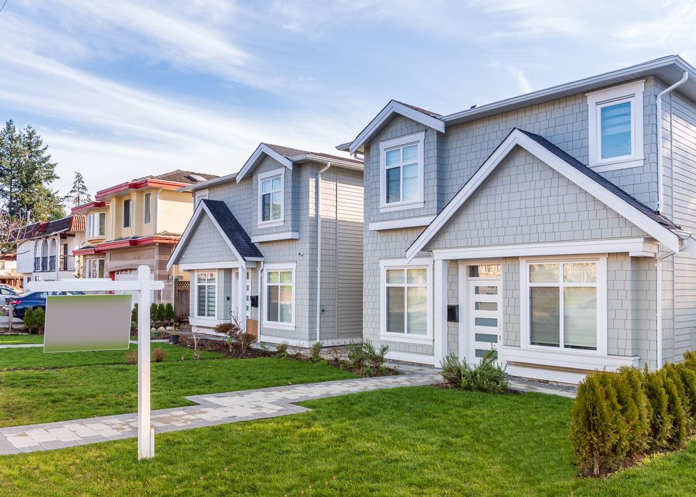 Row of Houses With Manicured Lawns, One With a Blank — Property Transfer Professionals In Wyong, NSW