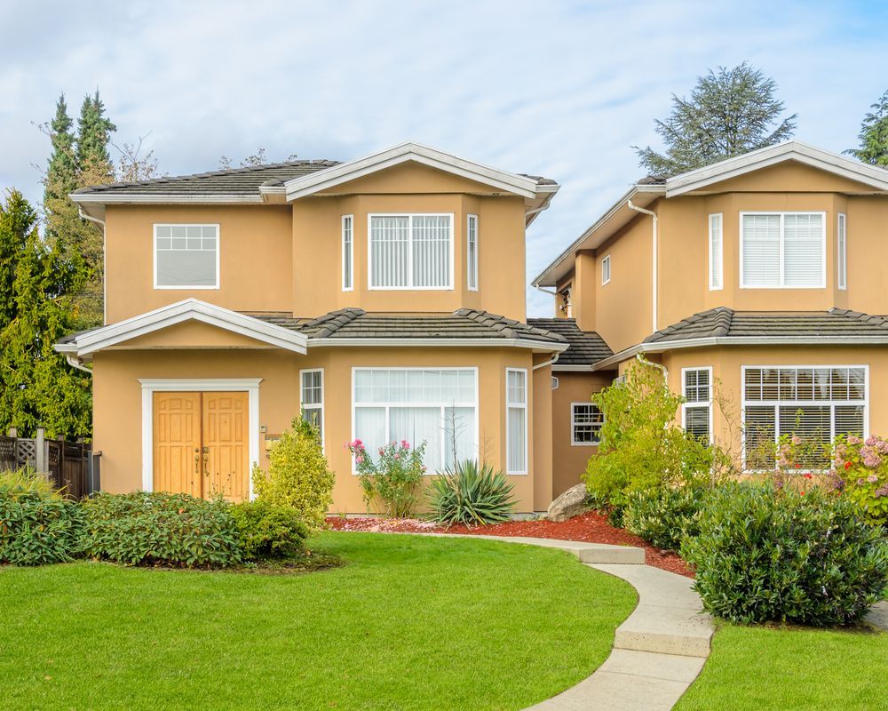 Two-story Tan Houses With White Trim, Green Lawns, and a Winding Walkway — Property Transfer Professionals in Wyong, NSW