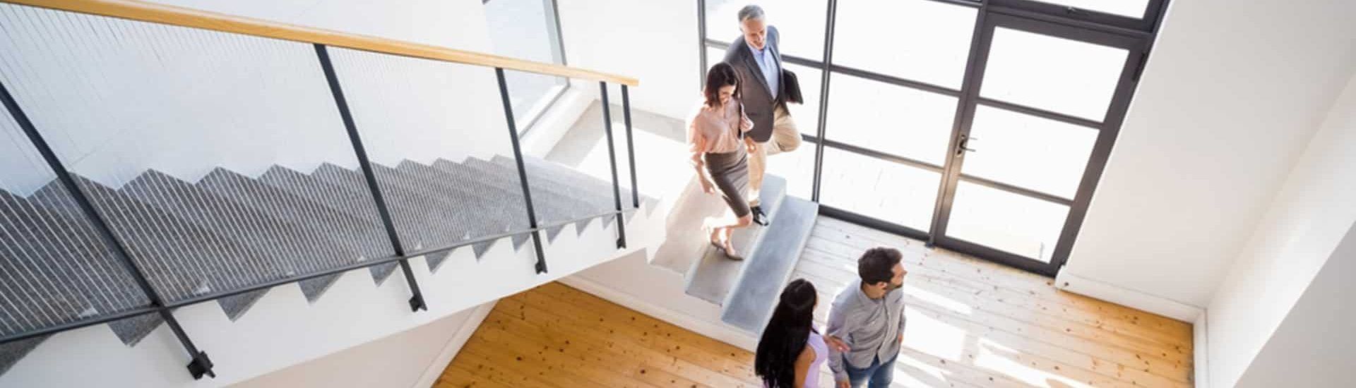 People Interacting in a Modern Building With Wooden Floors, Staircase — Property Transfer Professionals In Wyong, NSW