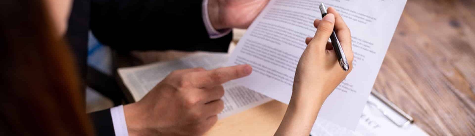 Hands Pointing at and Writing on a Document — Property Transfer Professionals In Bateau Bay, NSW