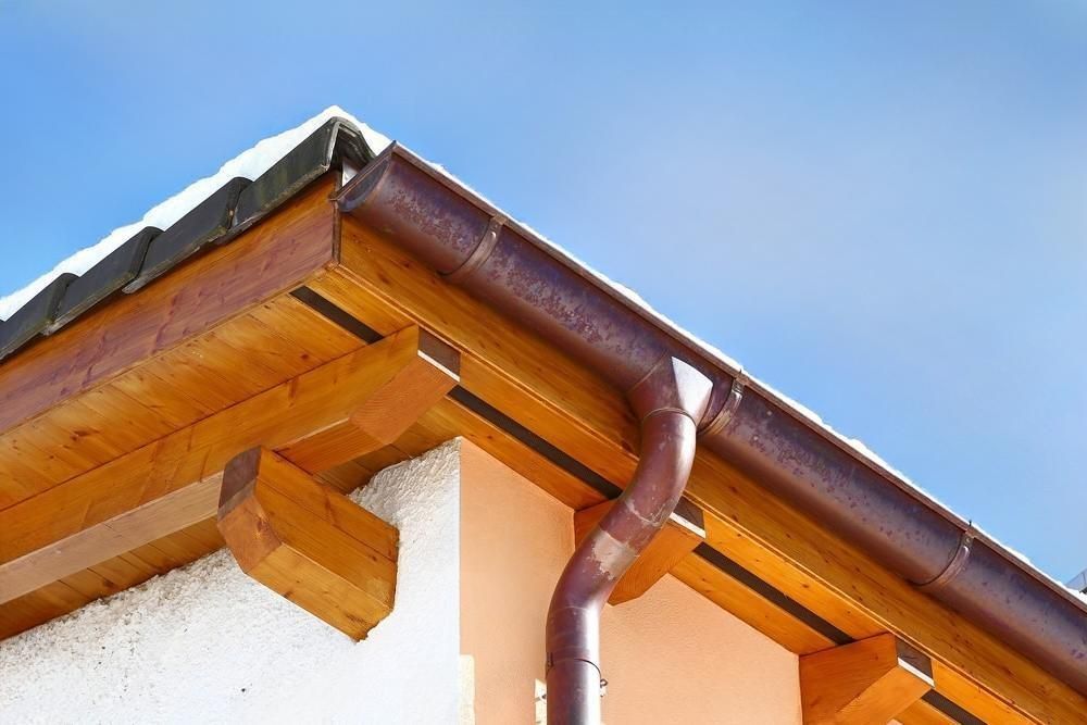 A close up of a gutter on the roof of a house