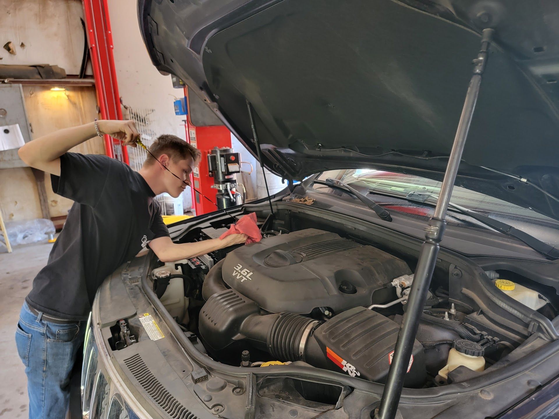 Mechanic Working on a Car Engine with the Hood Open | Rock's Tire & Auto