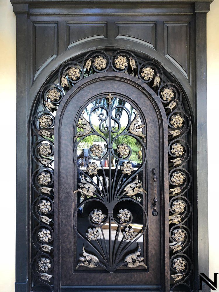 A wrought iron door with a floral design on it