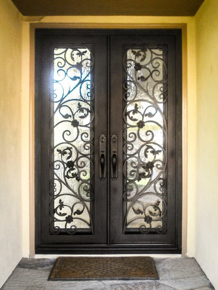 The front door of a house has a wrought iron design on it.