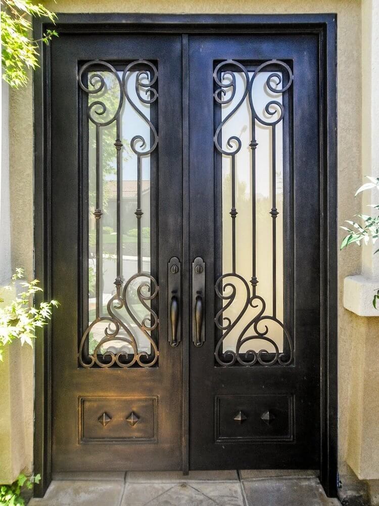A close up of a wrought iron door on a house.