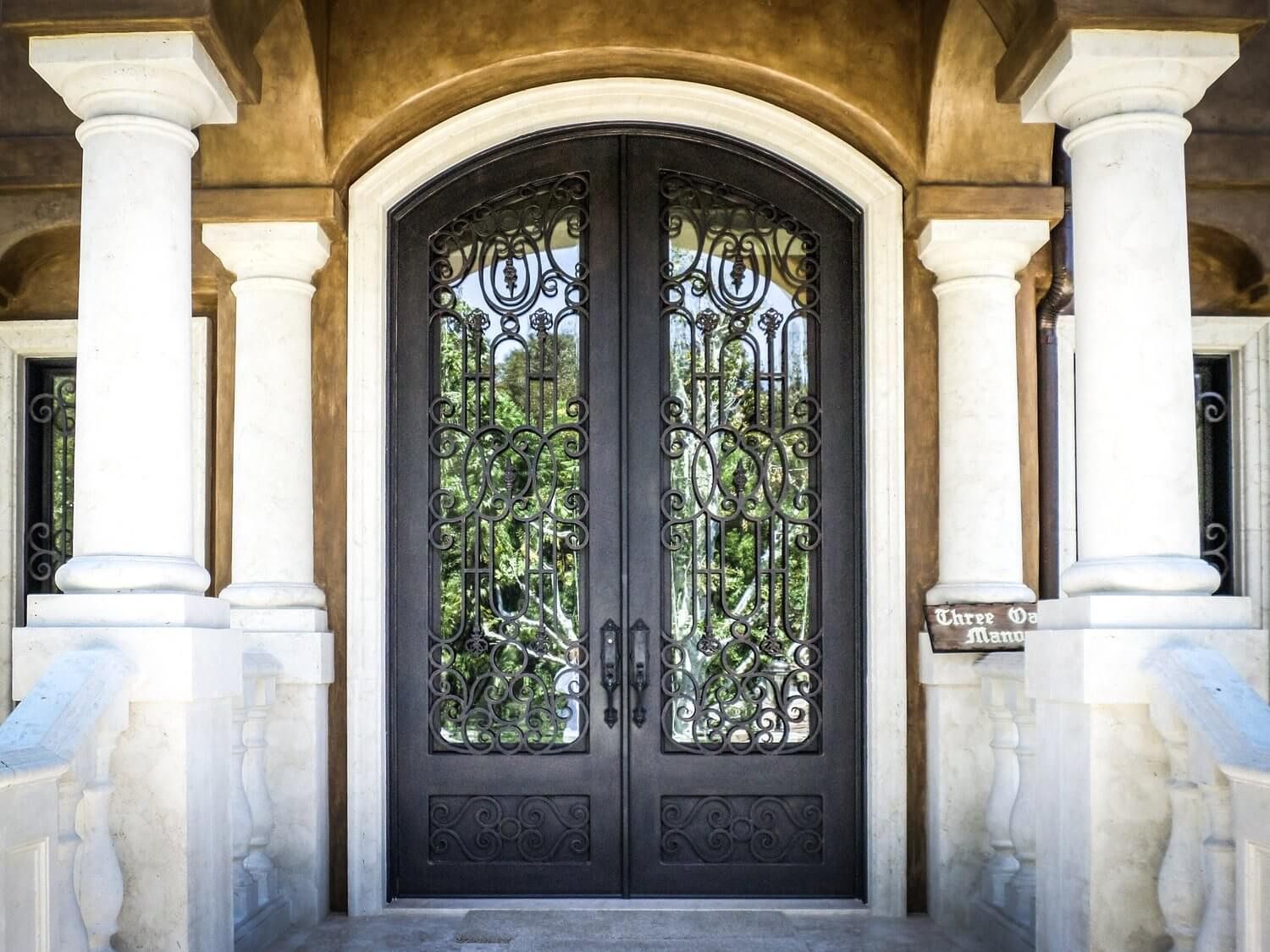 The front door of a house has a wrought iron design on it