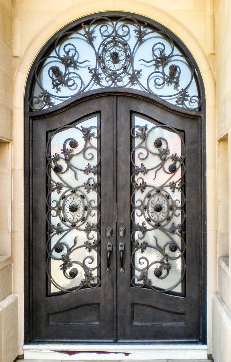 A wrought iron door with a fancy design on it