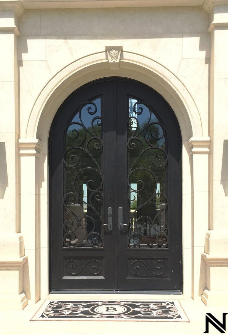A black door with a wrought iron design on it