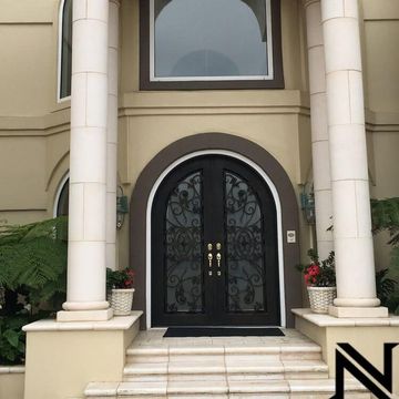 The front door of a house with a n on the side