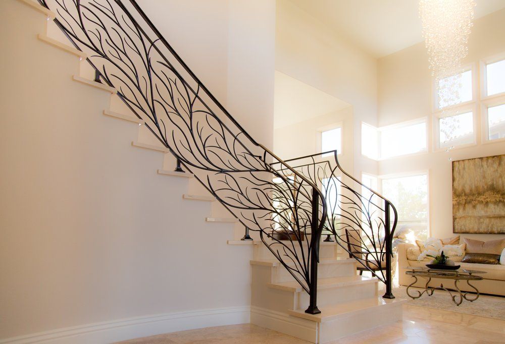 A staircase with a wrought iron railing in a living room