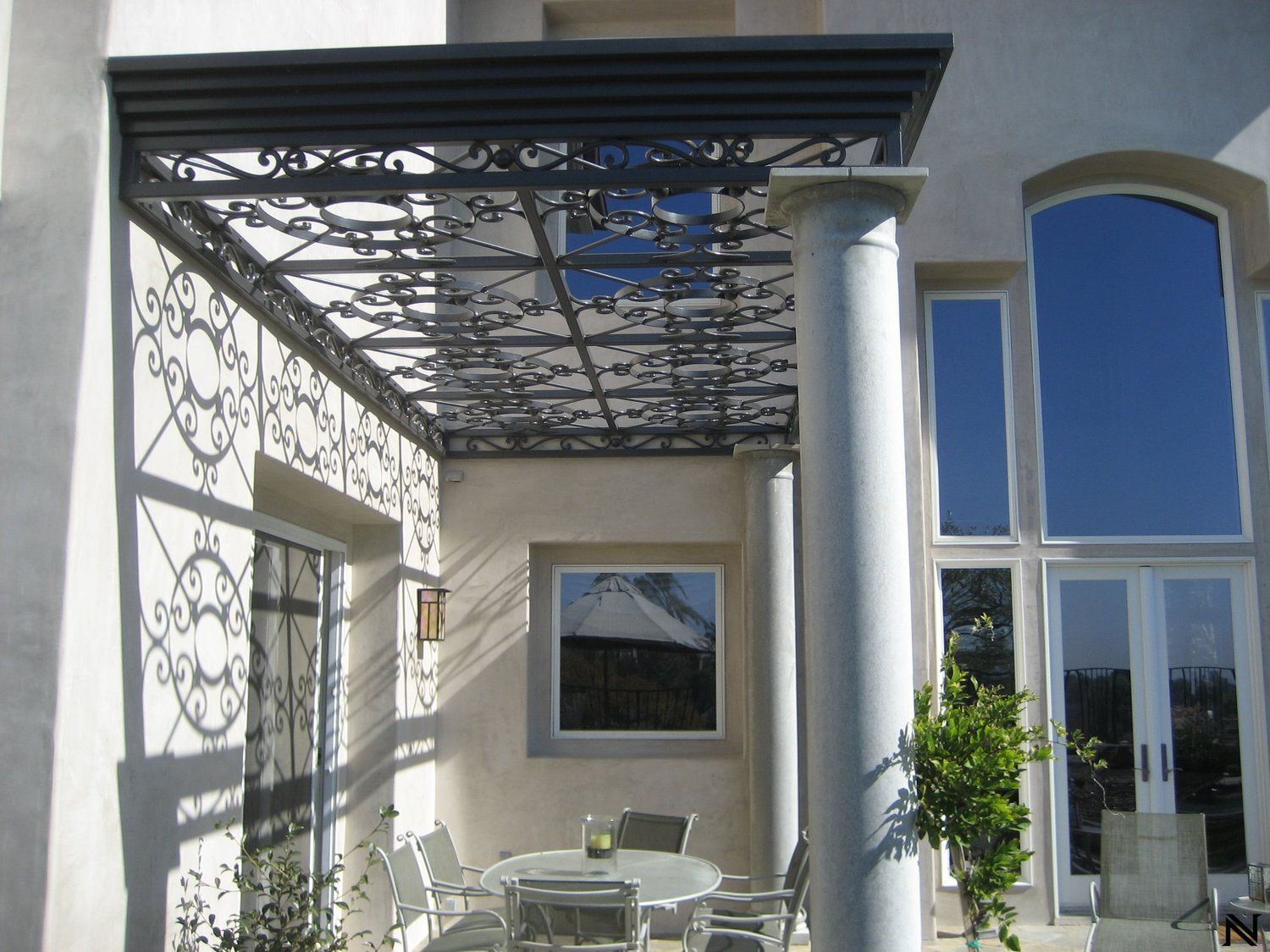 A wooden table with a metal frame is sitting on a concrete floor.