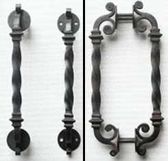 Three different types of wrought iron door handles on a white surface.