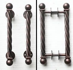 A close up of a door handle on a white surface.