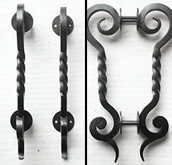 A black and white photo of a wrought iron door handle.