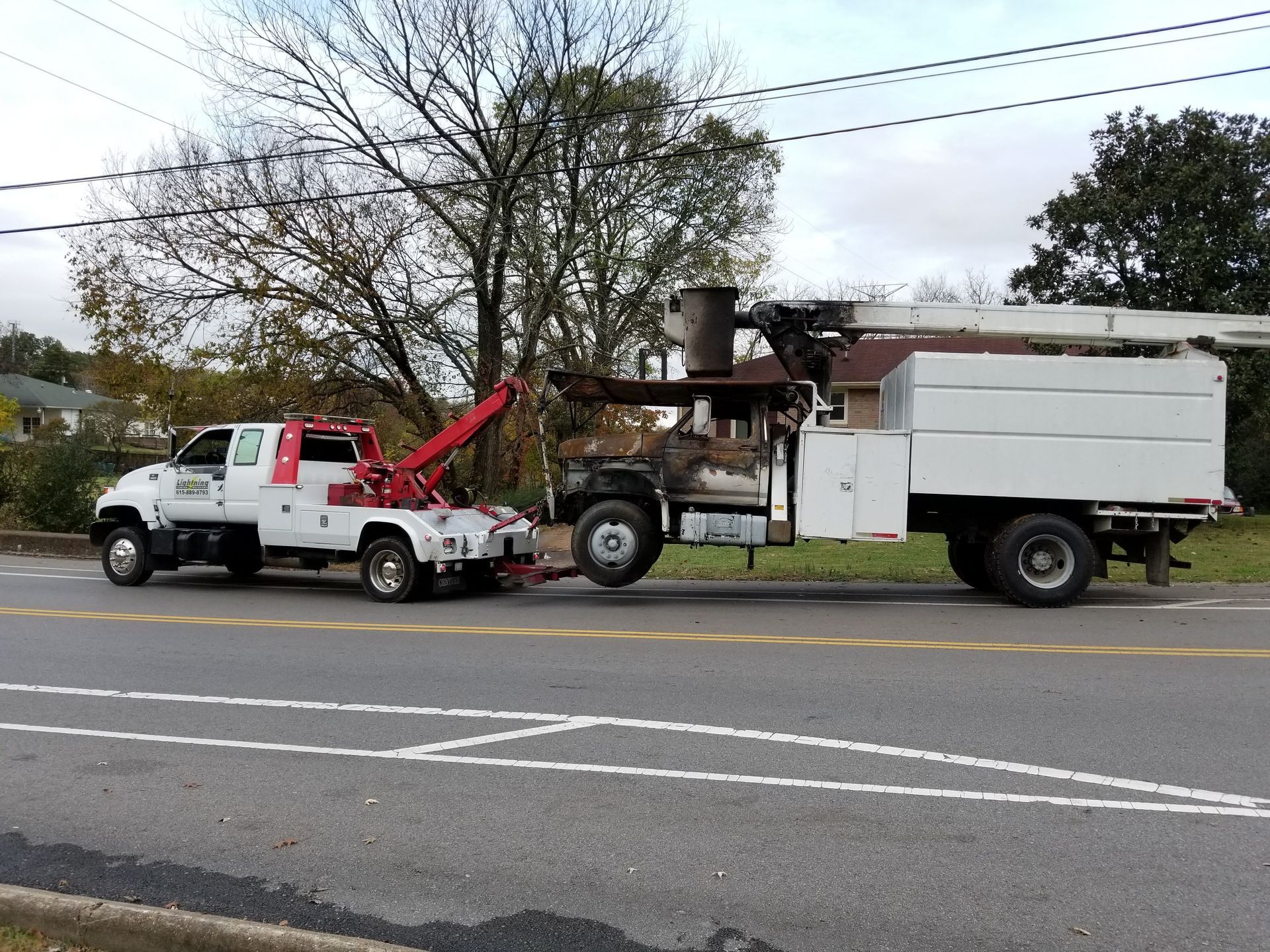 A tow truck with a crane on the back of it