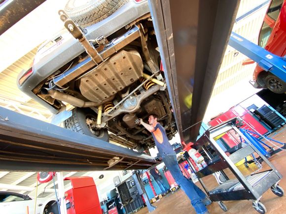 Mechanic Working On underside of Car — Autofirst Service & Repairs In  Mount Isa QLD