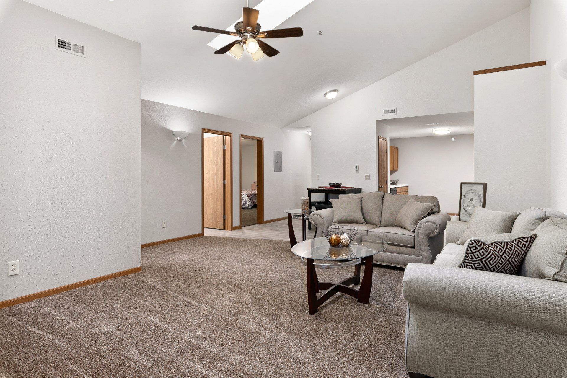 Fully furnished living room with couch, love seat, coffee table