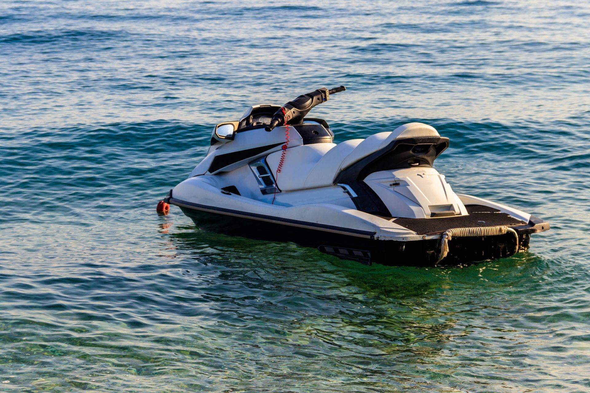 A jet ski is floating on top of a body of water.