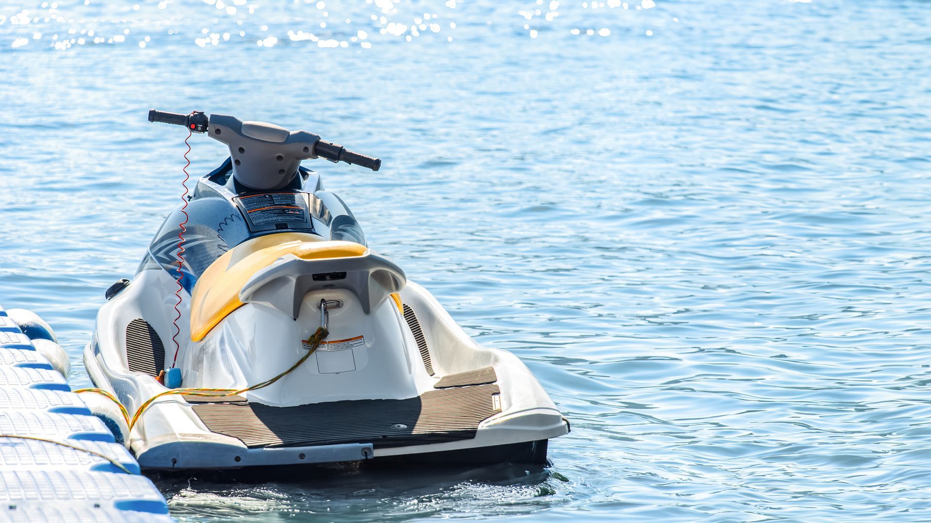 A jet ski is docked at a dock in the water.