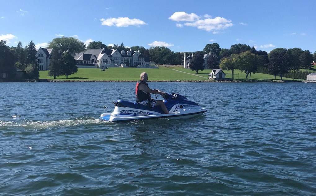 A man is riding a jet ski on a lake.