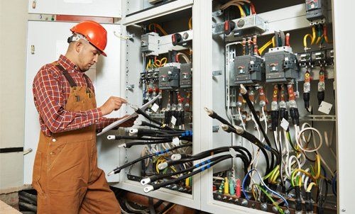 Experienced professional checking the wires before connecting them 