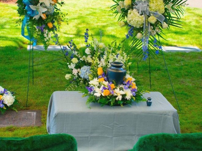 a table with flowers and a urn on it