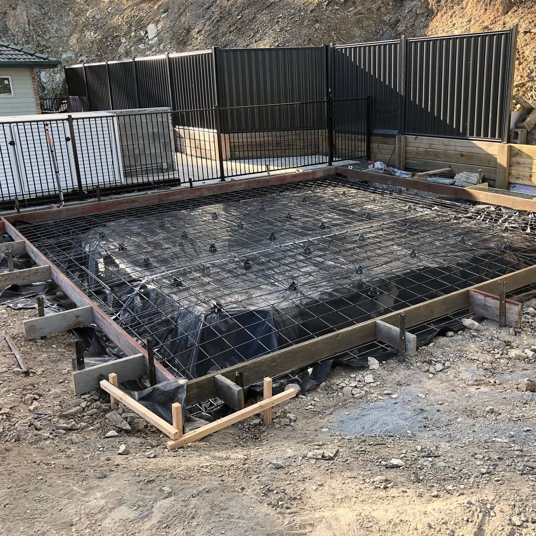 A construction site showing a concrete foundation formwork with steel rebar reinforcement prepared for a pour. — Sand & Stone in Burleigh Heads, QLD