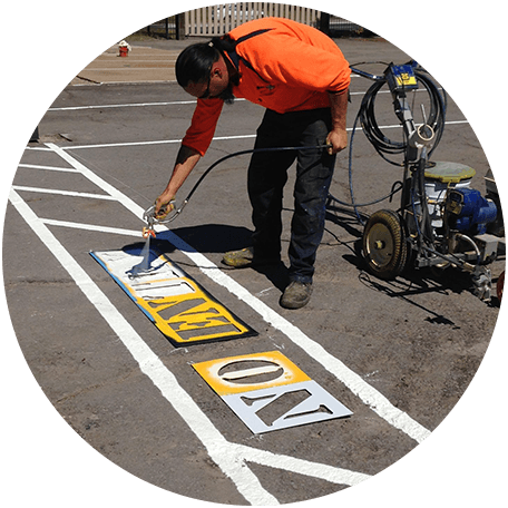 Man Painting And Coating Text On Road