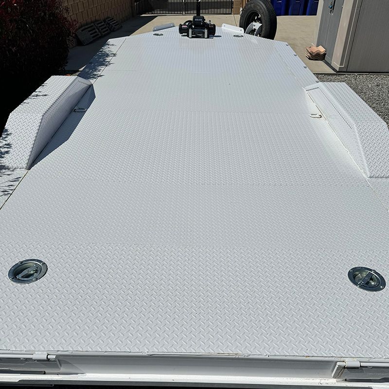 A Flatbed Car Trailer is parked in a driveway in front of a building