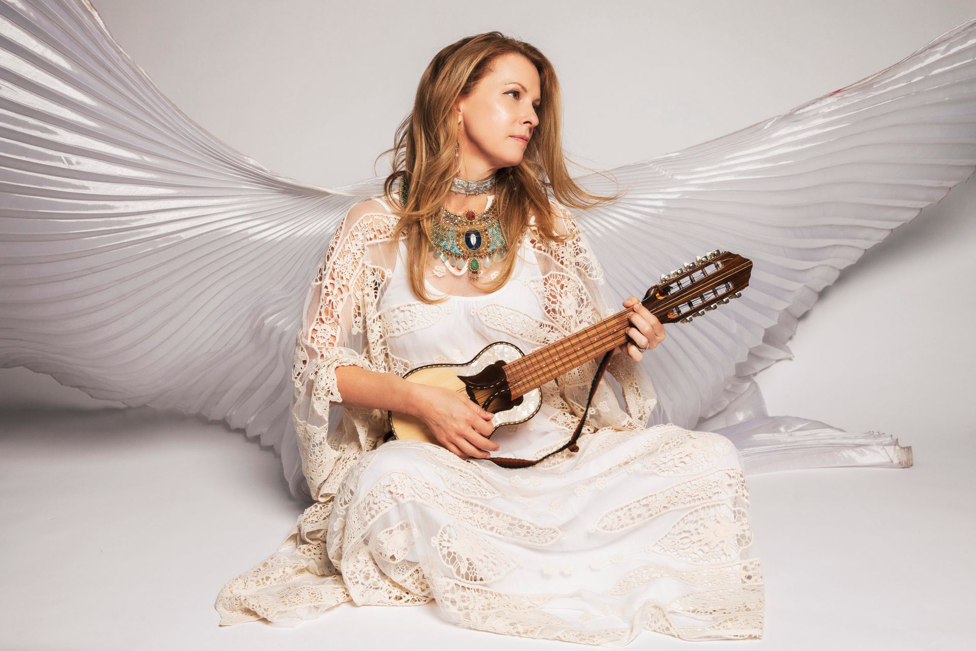 Image of Kimberley Haynes in white with angelic wings, for the song Grant Us Peace