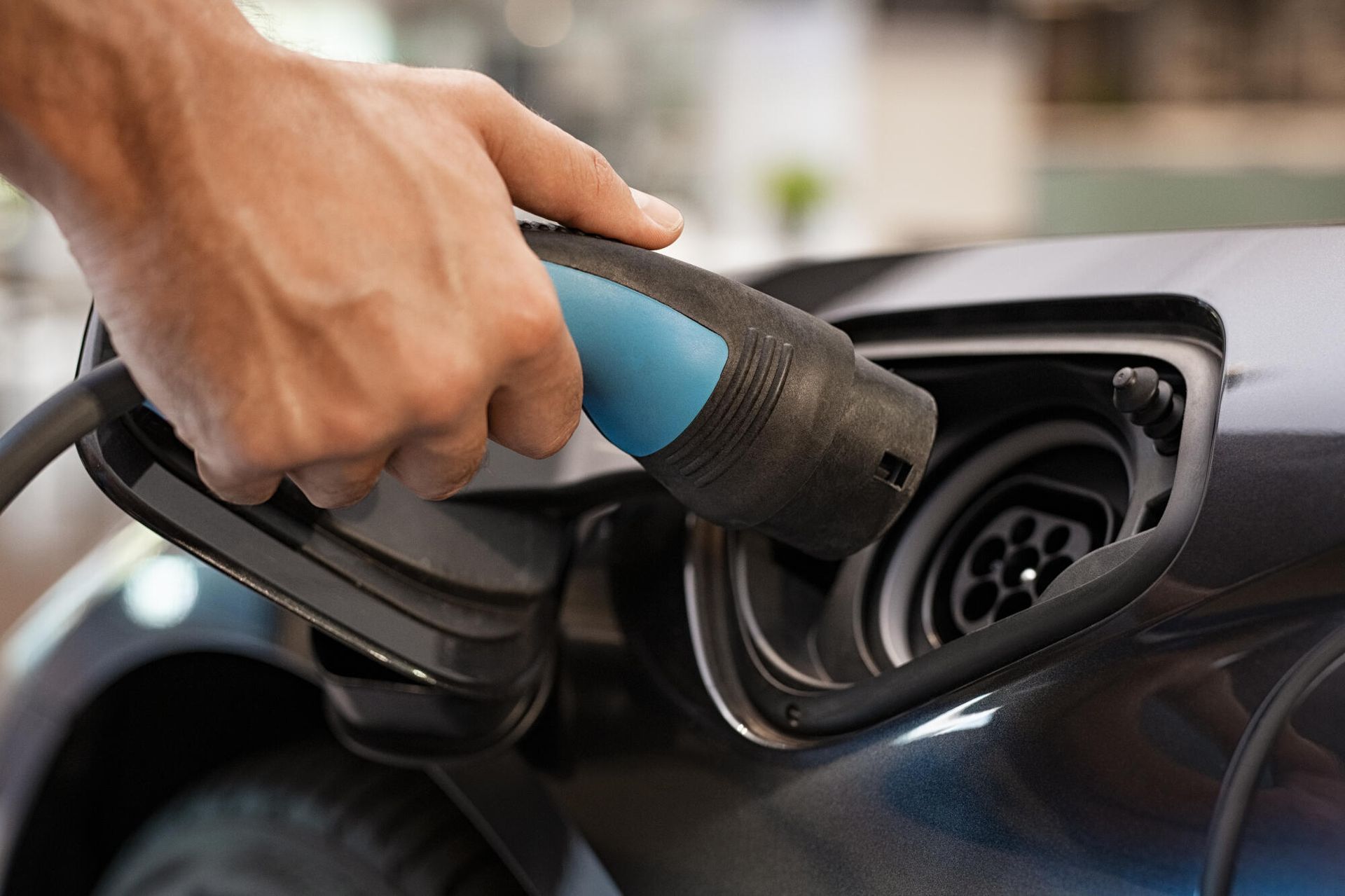 A person is charging an electric car with a charger.