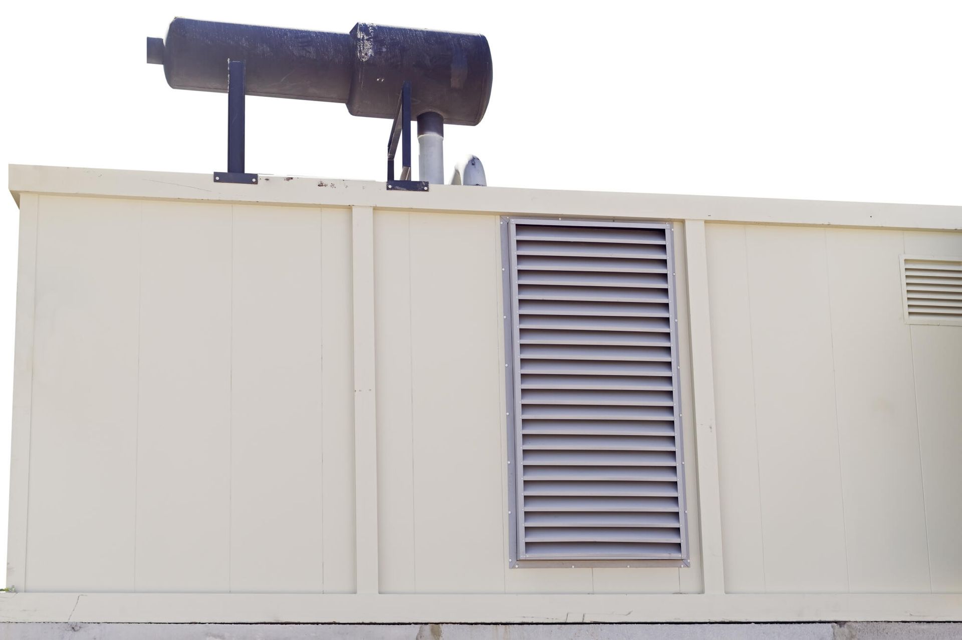 A white building with a black pipe on top of it