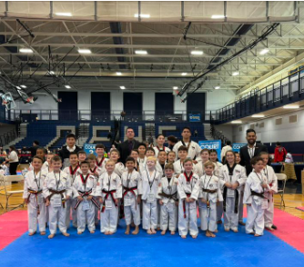 a group of kids are posing for a picture in a gym .