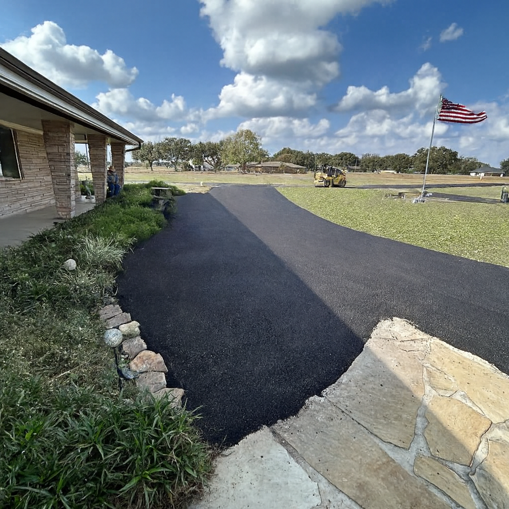 Asphalt Roller Compacting Fresh Black Asphalt on A Paved Surface — Sealy, TX — Sealy Paving, Inc.