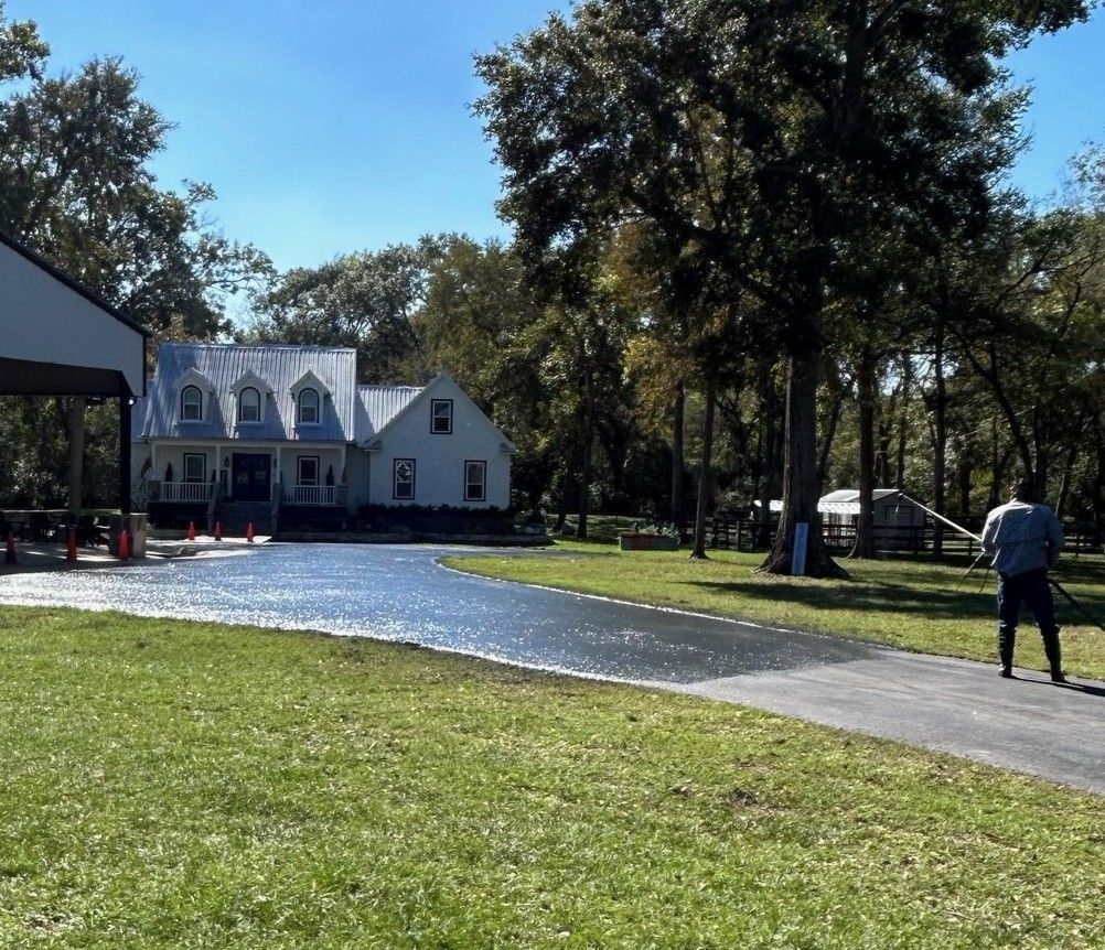 Applying Sealant to Asphalt in A Parking Lot — Sealy, TX — Sealy Paving, Inc. Applying Sealant to Asphalt in A Parking Lot — Sealy, TX — Sealy Paving, Inc.
