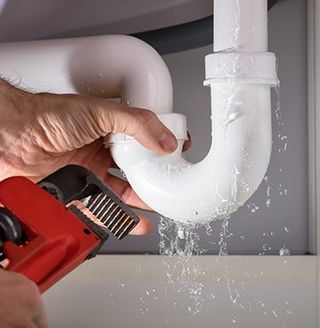 Fixing Sink Pipe With Adjustable Wrench — Forest Park, GA — Brawner Plumbing Service