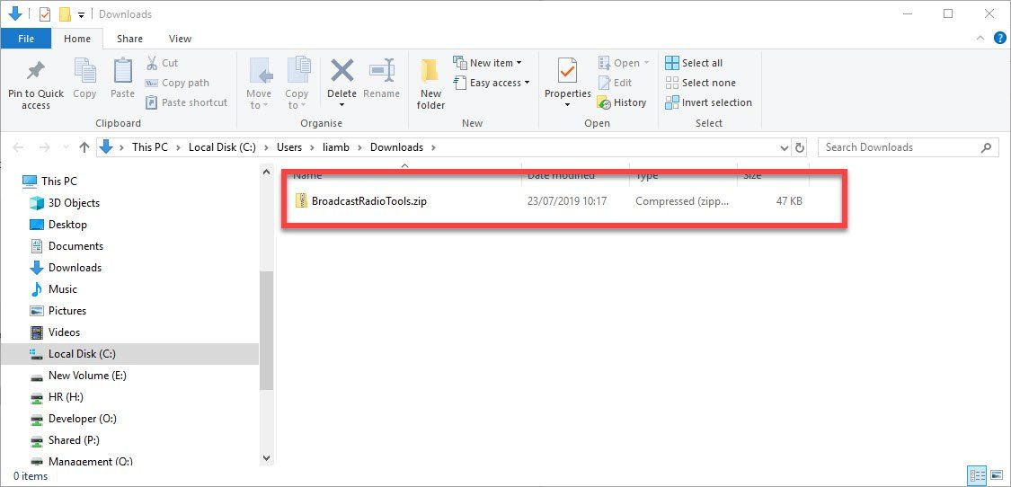 A computer screen with a red arrow pointing to a file.