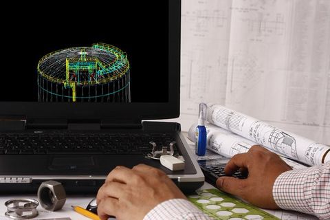Professional working on 3D model on laptop