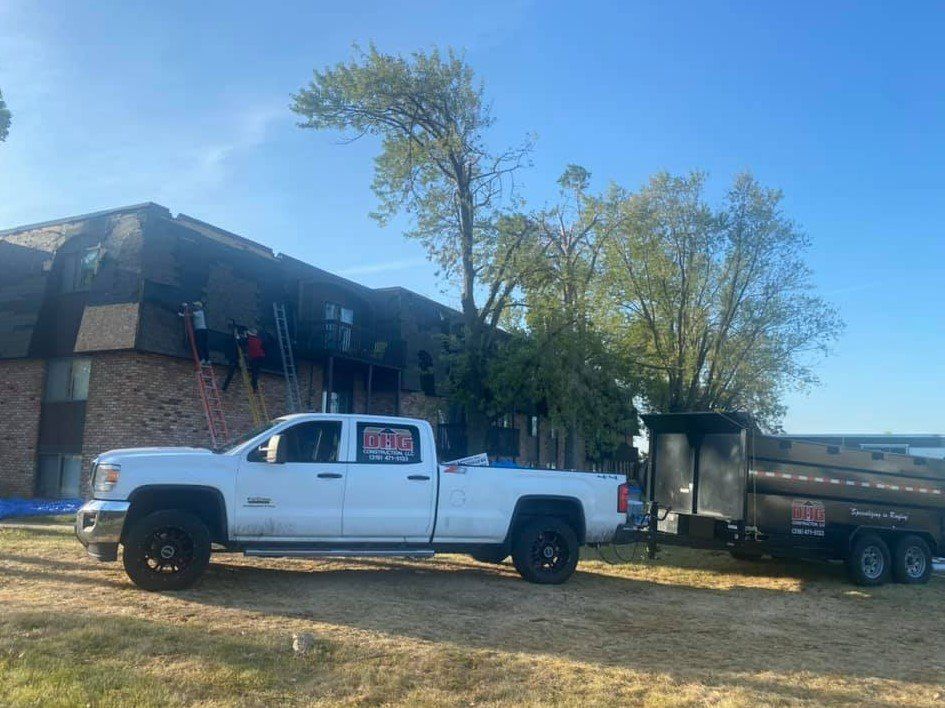 Construction Workers Installing Siding - West Liberty, IA - DHG Construction LLC