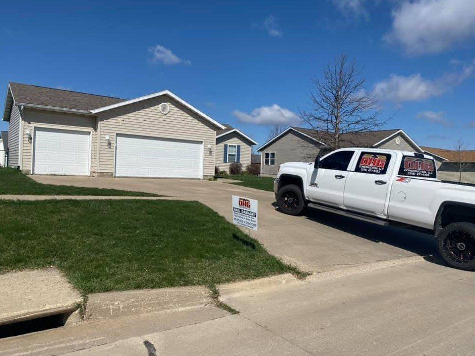 House With Company Pickup Truck Parked Outside - West Liberty, IA - DHG Construction LLC