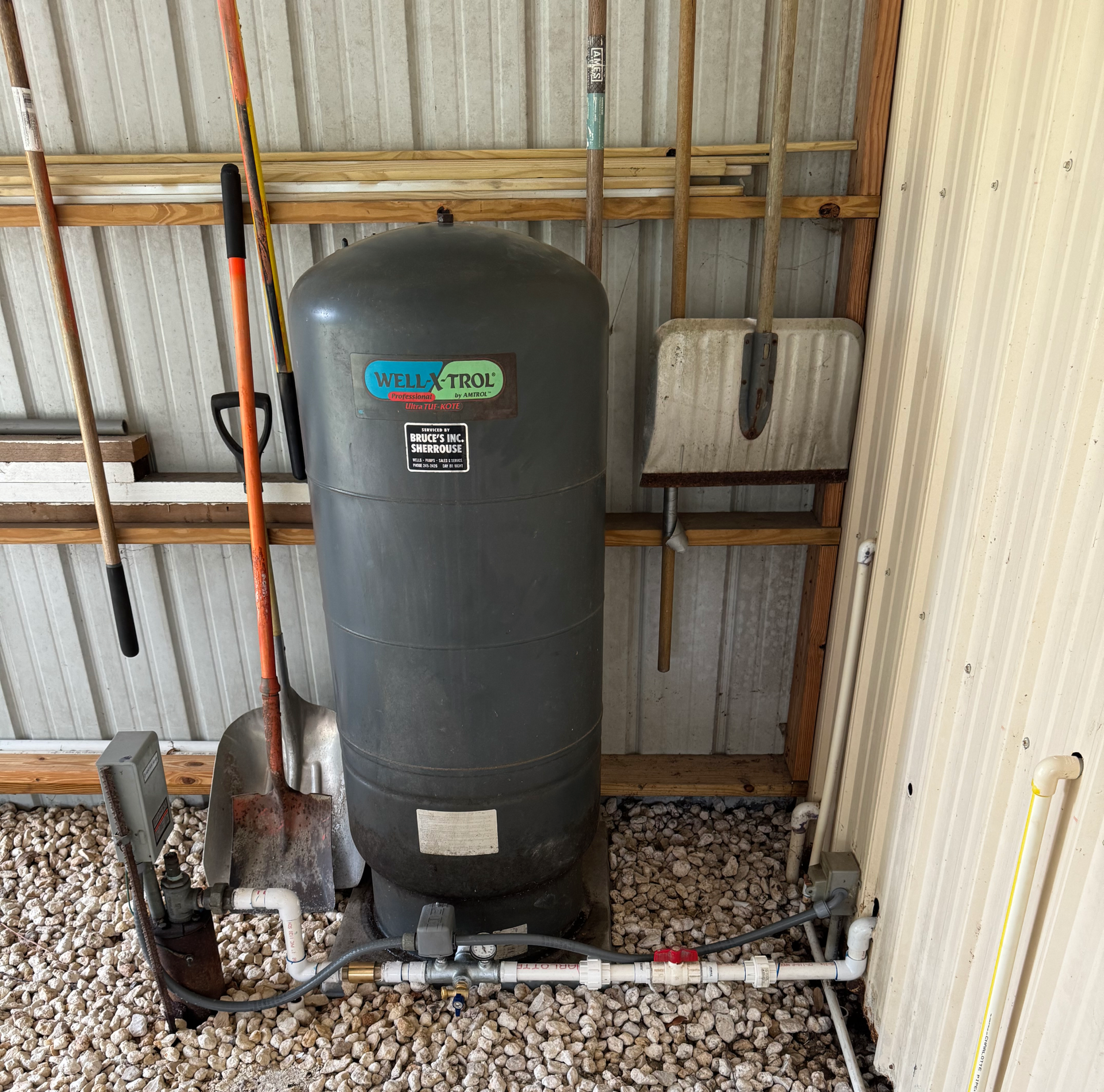 A plumber is fixing a sink in a kitchen.
