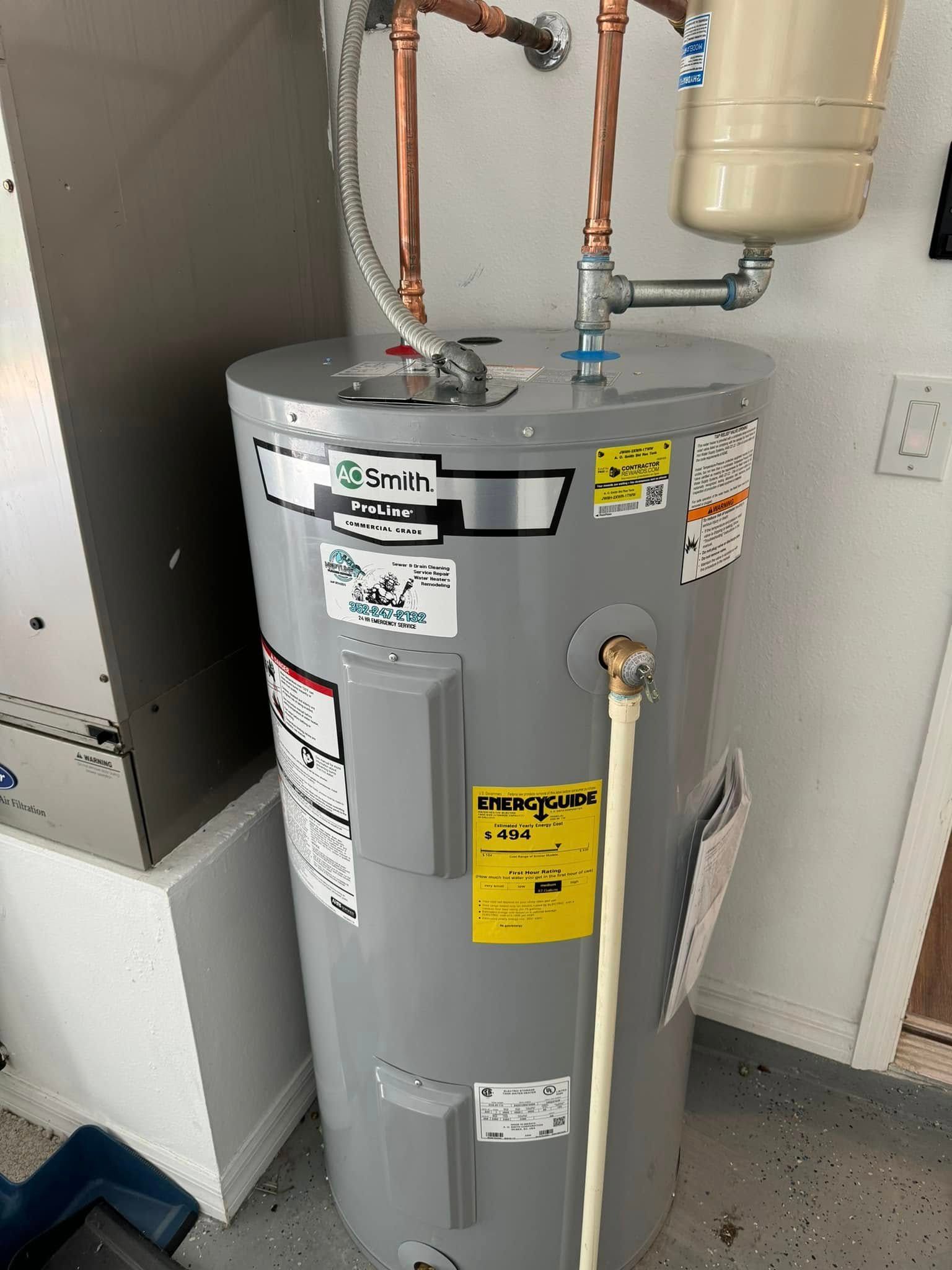 A water heater is sitting in a room next to a wall.