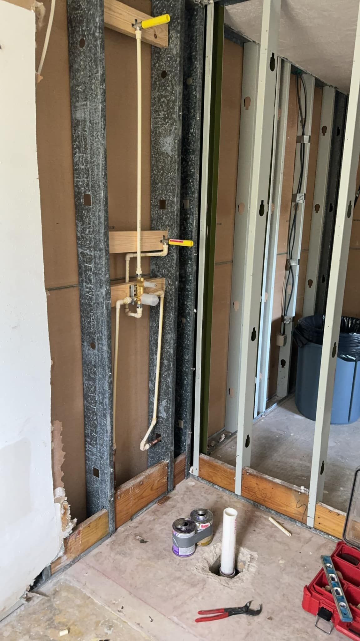 A bathroom under construction with a hole in the floor.