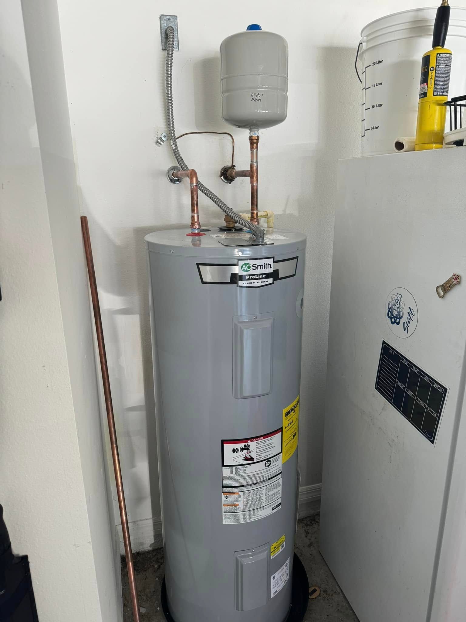 A water heater is sitting in a room next to a refrigerator.