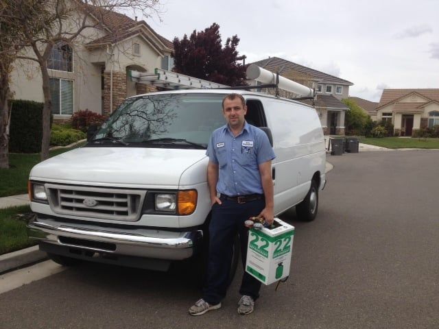 A man is standing in front of a white van
