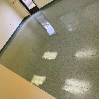 A room with a green tile floor and a door.